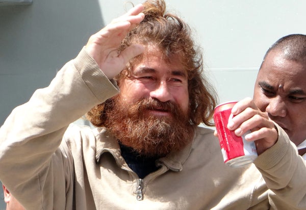 Salvadoran castaway Jose Salvador Alvarenga waving, smiling and drinking from a can outside a hospital on the Marshall Islands.